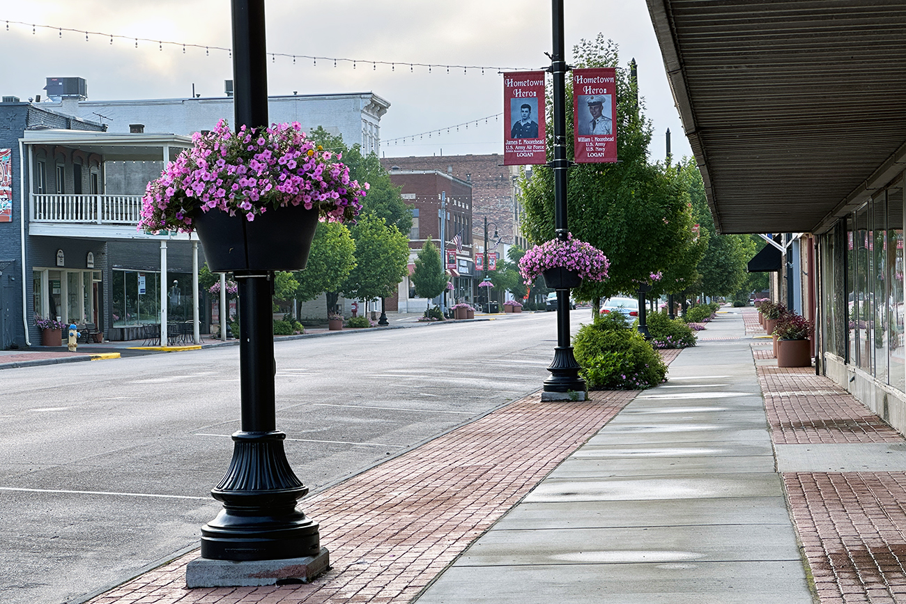 Looking down Main Street in Logan Ohio with flower plantings on the poles